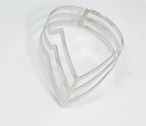 Macro shot of a silver hollow triangle punk arm cuff with smooth metallic finish
