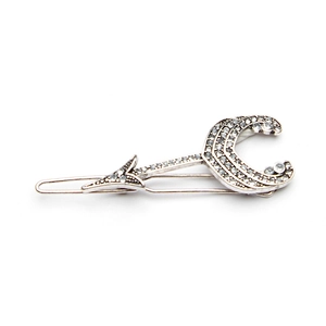 Detailed close-up of a silver alloy moon and arrow hair clip with sparkling rhinestones