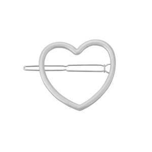 Detail of silver hollow heart hair clip showing minimalist metal design and secure back clip