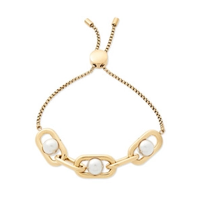 Detail of gold chain bracelet featuring three pearls and adjustable sliding bead closure