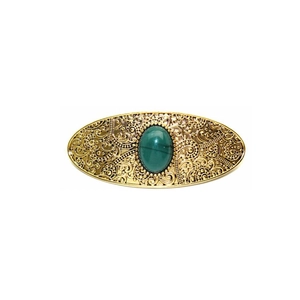 Vintage gold oval hair clip with ornate filigree patterns and deep green gemstone center