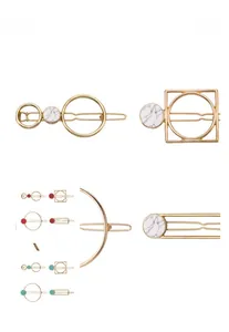 Detailed macro view of geometric hair clips with marble texture and gold alloy finish