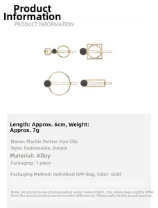 Detailed macro view of golden geometric alloy hair clip with black marble stone inlay