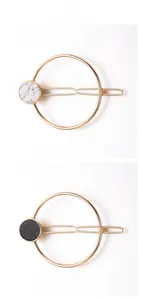 Detail of round geometric hair clips with marble texture and gold alloy finish