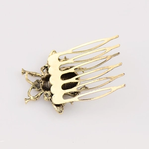 Detailed close-up of a vintage bronze alloy bee-shaped hair comb with 5-tooth structure