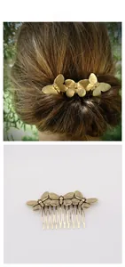 Detail of vintage gold butterfly hair comb featuring three intricate filigree butterfly motifs