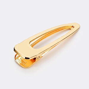 Minimalist hollow metal hair clip with gold brushed finish and secure grip design
