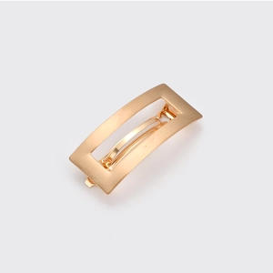 Minimalist geometric gold metal hair clip with a sleek brushed finish and rectangular shape