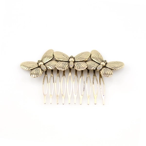 Vintage style metal butterfly hair comb in antique gold finish for elegant hair styling