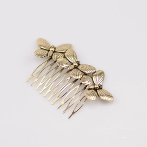Vintage bronze butterfly hair comb with detailed metal engraving in minimalist forest style