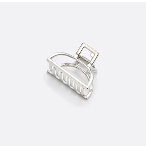 Close-up of a silver semi-circular alloy hair claw clip with a sleek metallic finish