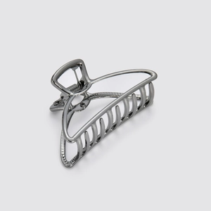 Close-up of gunmetal grey alloy hair claw clip with polished metallic finish and strong spring