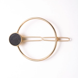 Minimalist gold round hair clip with black marble pattern for women in geometric style