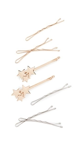 Detailed set of seven rose gold and silver star hairpins on white background
