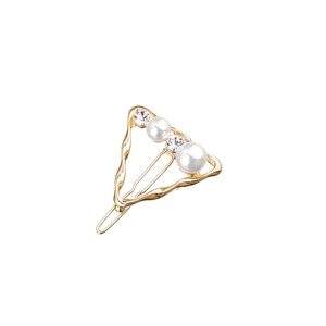 Detailed close-up of a gold triangle hair clip with inlaid pearls and sparkling rhinestones