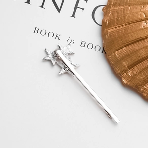 Detail view of the silver alloy star hair clip showing the secure spring metal clamp mechanism