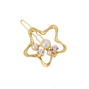 Detailed shot of a gold star hair clip featuring white pearls and sparkling rhinestones