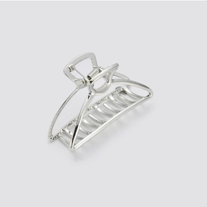 Detailed view of polished silver metal hair claw clip with strong spring and sleek curves