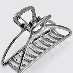 Macro detail of dark grey metallic claw hair clip with sturdy metal spring mechanism