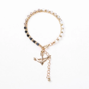 Detail of beaded bracelet with gold arrow charm, faceted multi-color beads, and lobster clasp