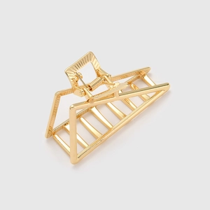 Macro shot of gold geometric triangle hair claw clip with strong metal spring mechanism