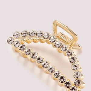 Elegant gold metal hair claw clip with sparkling rhinestones and a smooth spring mechanism