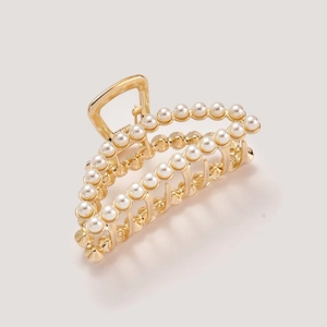 Elegant gold metal hair claw clip with double rows of pearls in a crescent shape design