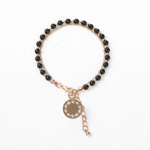 Dual-layer beaded bracelet with black crystals and a sparkling gold crystal circle pendant