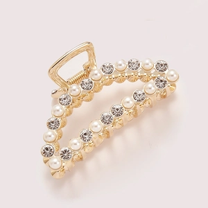 Elegant gold hair claw clip featuring alternating rows of white pearls and sparkling rhinestones