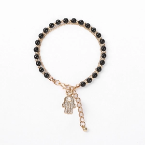 Detail of double-layer beaded bracelet with Hamsa Hand charm and sparkling crystals