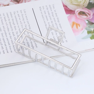 Detail view of large rectangular silver metal hair claw clip with strong spring and teeth