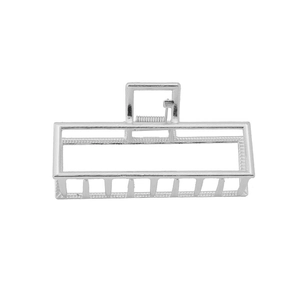 Detailed macro view of silver alloy hair claw with geometric hollow frame design
