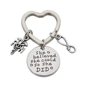 Nurse keychain gift featuring RN caduceus and She Believed She Could So She Did charms