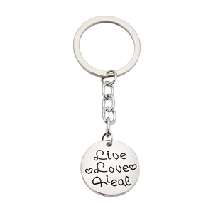 Inspirational silver round pendant keychain with Live Love Heal engraving and heart detail