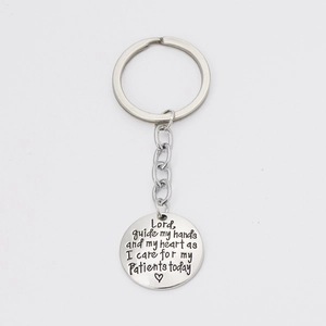 Silver stainless steel keychain engraved with a medical prayer and heart for nurses