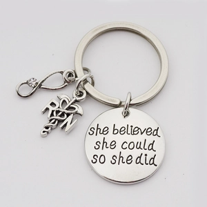 Close-up of RN caduceus charm and she believed she could so she did engraved plate