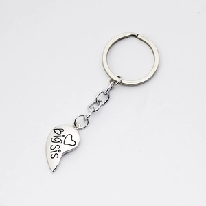 Detailed view of silver heart keychain with black big sis engraving for sisters