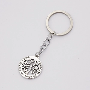 Detailed view of silver tree of life keychain with Mom heart family engraving