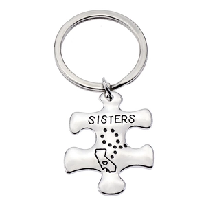 Polished silver puzzle piece keychain with California map and Sisters engraving