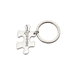 Silver puzzle piece keychain with Sisters engraving and heart detail for best friends
