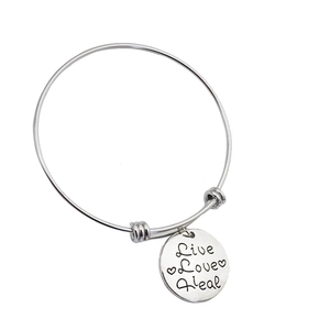Adjustable silver bangle with Live Love Heal engraved round charm and heart accents