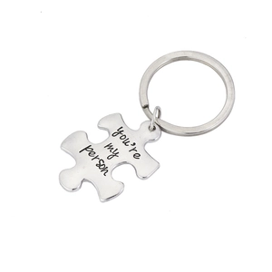 Polished puzzle-shaped keychain with engraved text for couples and best friends