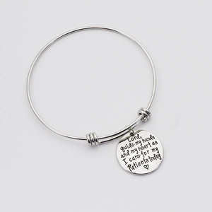 Macro view of adjustable silver bracelet with Lord Guide My Hands medical prayer charm