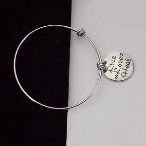 Silver adjustable bangle bracelet with Live Love Heal engraved round pendant charm