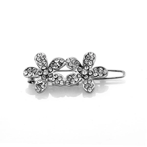 Macro shot of silver rhinestone hair clips featuring a twin floral pattern design