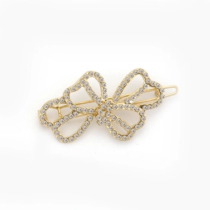 Elegant gold butterfly hair clip with sparkling rhinestones on a clean white background