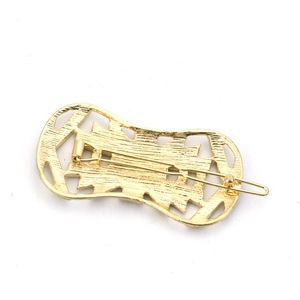 Vintage geometric gold metal hair clip with hollow pattern and spring clamp mechanism