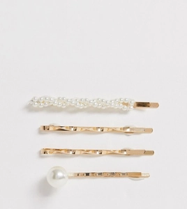 Detail of 4-piece elegant gold hair clip set with white pearls on grey background