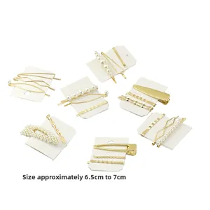 Detail view of pearl hair clip set in gold alloy finish showing various patterns