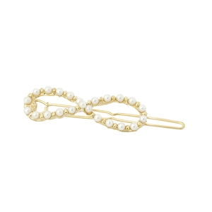 Elegant gold infinity shaped hair clip with small white pearls for minimalist women styling